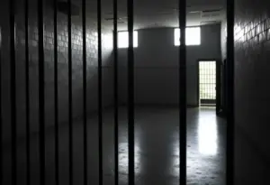 Somber empty prison cell representing death row